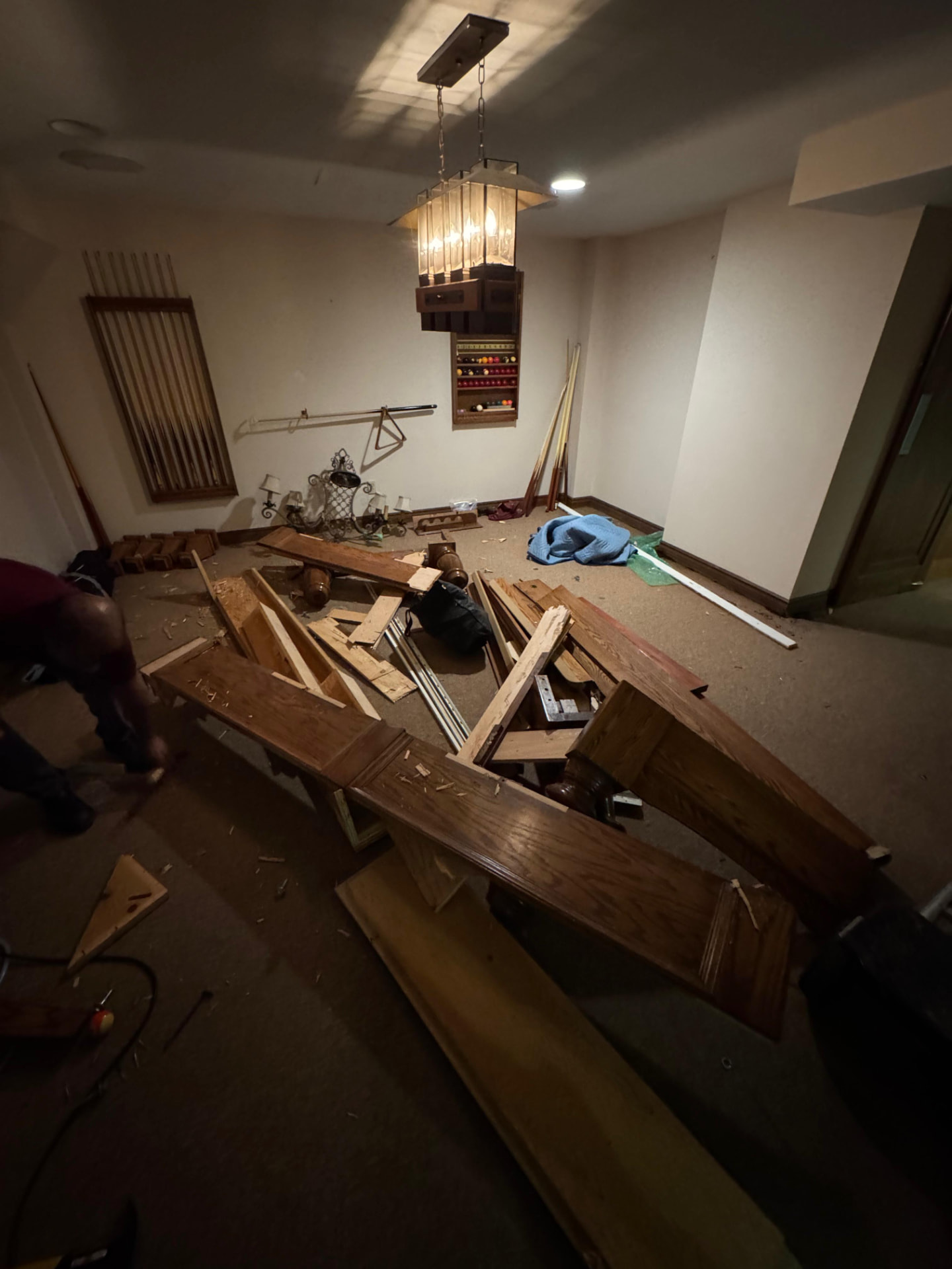 Before: basement pool table removal — space filled with junk